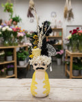 Decorative head with floral and feather accents on a white background
