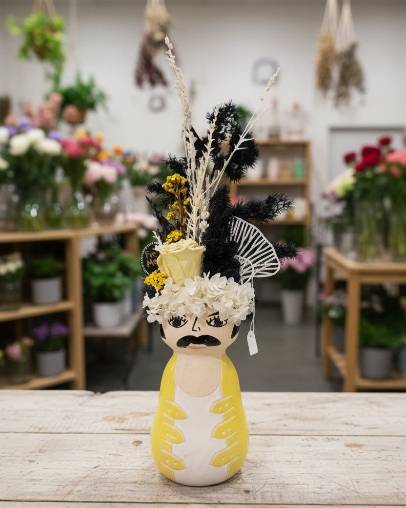 Decorative head with floral and feather accents on a white background