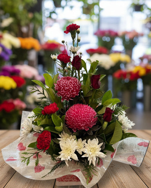 Floral arrangement with red and pink flowers on a white background